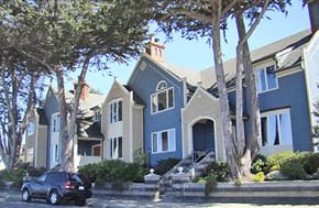 Pacific Grove apartment for rent - A black car is parked on the street in front of a blue house.