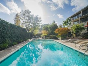 Palo Alto apartment for rent - a swimming pool with a building in the background
