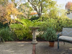 Palo Alto apartment for rent - a patio with a bird bath and a chair