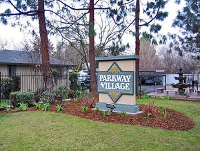 Fresno apartment for rent - A sign that says Parkway Village in front of a house.