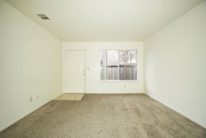 Fresno apartment for rent - A room with a carpeted floor and a window showing a snowy scene outside.