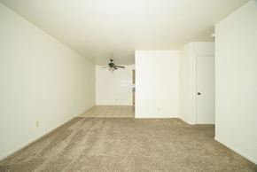 Fresno apartment for rent - A room with a carpeted floor and a window showing a snowy scene outside.