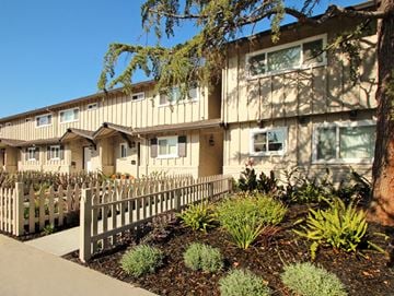 Palo Alto apartment for rent - a row of houses with a white fence