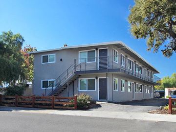 Palo Alto apartment for rent - a gray house with stairs and a wooden fence