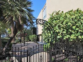 Palo Alto apartment for rent - an apartment building with a gate and a palm tree