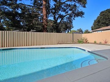Palo Alto apartment for rent - a swimming pool in a backyard with a fence