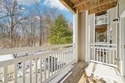 Perryville apartment for rent - A wooden deck with a white railing and a view of a snowy landscape.