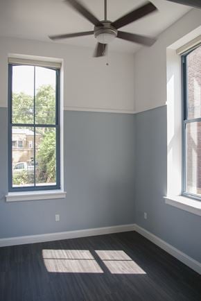 Pittsburgh apartment for rent - an empty room with two windows and a ceiling fan