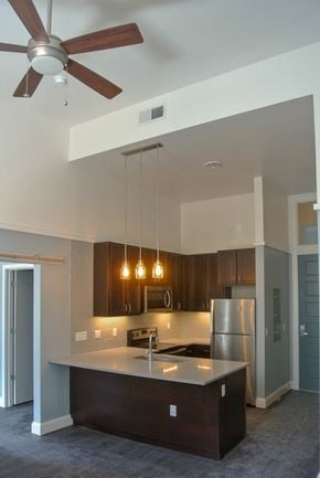 Pittsburgh apartment for rent - an empty kitchen with a ceiling fan and lights