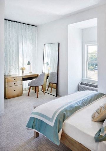 Amityville apartment for rent - a bedroom with a bed and a mirror