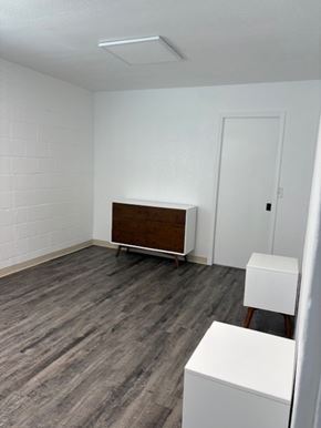 Modesto house for rent - A room with a white wall and a wooden cabinet.