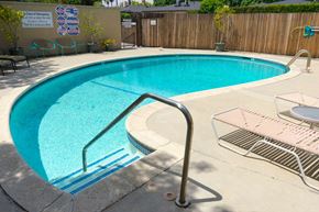 Pasadena apartment for rent - a swimming pool at a hotel with chairs and a fence