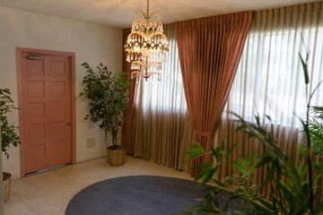 Pasadena apartment for rent - a living room with a chandelier and curtains and a door