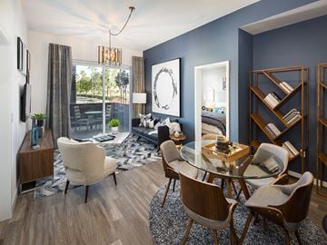 Fullerton apartment for rent - A modern living room with a glass table and chairs.