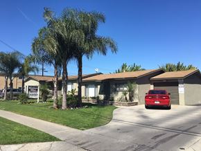 Downey apartment for rent - a house with a red car parked in front of it