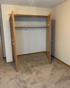 Dawson townhouse for rent - an empty bedroom with a closet with a door open
