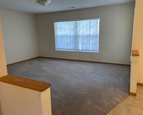 Dawson townhouse for rent - an empty living room with a large window