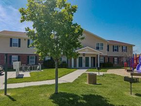North Platte apartment for rent - a building with a yard and a tree in front of it