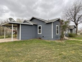 Abilene apartment for rent - A blue house with a white door and windows.