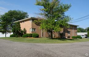 Lansing apartment for rent - A large house with a driveway in front of it.