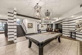 Charlotte apartment for rent - a pool table in a game room with two pendant lights