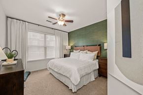 Charlotte apartment for rent - a bedroom with a bed and a ceiling fan