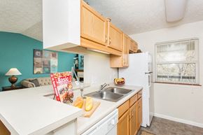 Indianapolis apartment for rent - a kitchen with a sink and a refrigerator