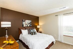 Indianapolis apartment for rent - a bedroom with a bed and a desk and a window