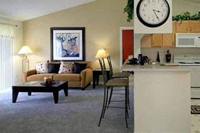 Fort Wayne apartment for rent - a living room and kitchen with a clock on the wall