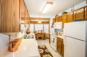 Fishers apartment for rent - a kitchen with white appliances and wooden cabinets