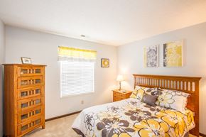Fishers apartment for rent - a bedroom with a bed and a dresser