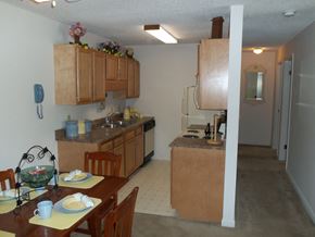 Springfield apartment for rent - a kitchen and dining room with wooden cabinets and a table