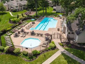 Fishers apartment for rent - an aerial view of a swimming pool and patio with chairs