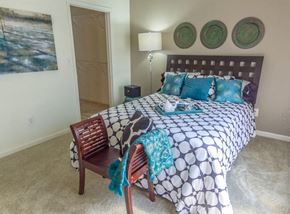 Fishers apartment for rent - a bedroom with a bed and a chair