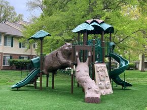 Fishers apartment for rent - a playground with a bear playing on a slide