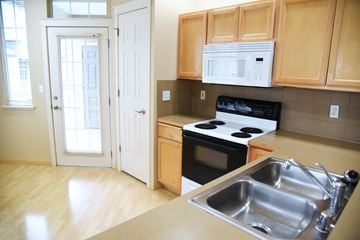 Spokane apartment for rent - a kitchen with a sink and a stove and a door