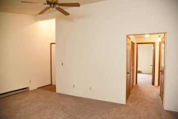 Spokane apartment for rent - a living room with a ceiling fan and a carpet