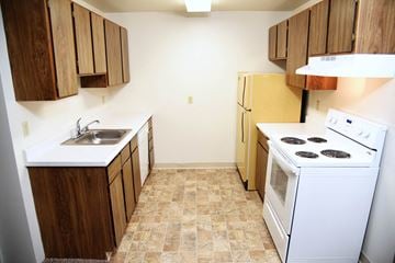 Spokane apartment for rent - a kitchen with a stove refrigerator and a sink