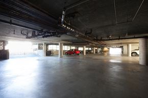 San Mateo apartment for rent - a large parking garage with a red car in the distance