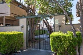 Santa Clara apartment for rent - the gate to the entrance of a building with a fence and trees
