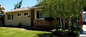San Jose house for rent - A house with a yellow siding and a red brick chimney.