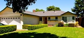 San Jose house for rent - A house with a white garage door and a brown roof.