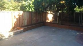 San Jose house for rent - A backyard with a wooden fence and a concrete patio.