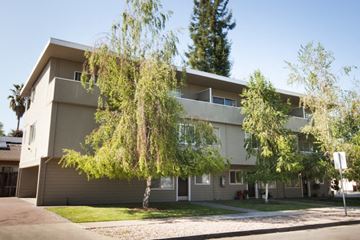 San Jose apartment for rent - the exterior of an apartment building with trees in front of it