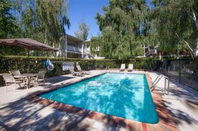 San Jose apartment for rent - a swimming pool with chairs and umbrellas