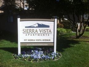 Mountain View apartment for rent - a sign apartments on the grass with flowers