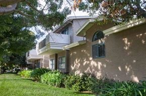 Mountain View apartment for rent - a beige house with a window and a lawn