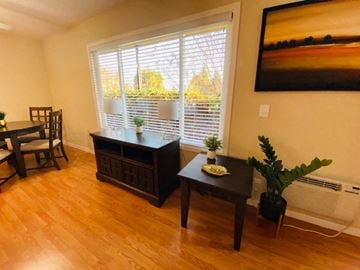 Mountain View apartment for rent - a living room with a large window and a table