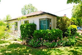 Mountain View condo for rent - A white house with a green door and a garden in front.