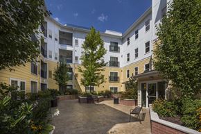 Salt Lake City apartment for rent - an outdoor courtyard of an apartment building with benches and plants